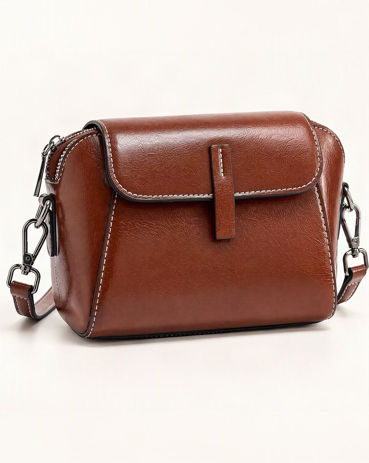 Cowhide Oil-Wax Leather Small Crossbody Bag — front three-quarter view on a warm white background