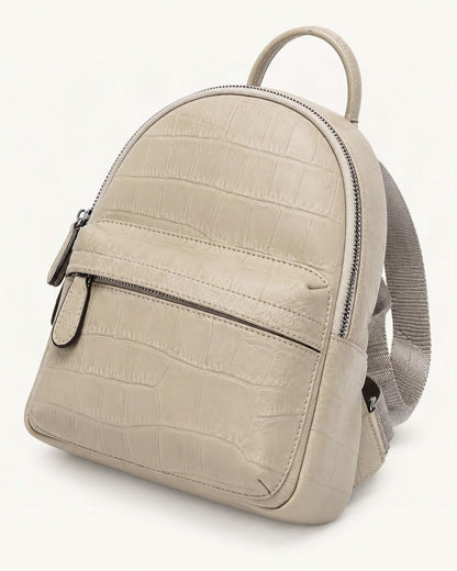 Top-Grain Cowhide Small Backpack — front three-quarter view on a warm white background