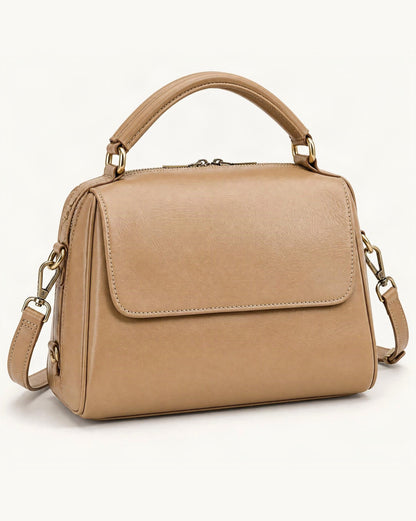Cowhide Leather Boston Shoulder Bag — front three-quarter view on a warm white background