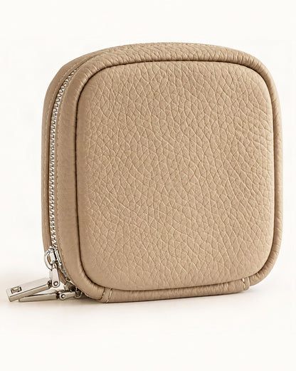 Pebbled Leather Mini Cosmetic Pouch — front three-quarter view on a warm white background
