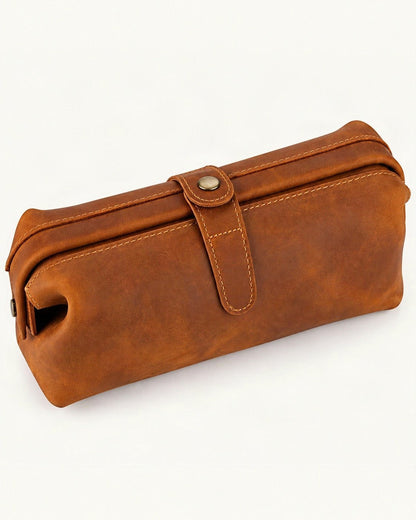 Top-Grain Cowhide Cosmetic Pouch — front three-quarter view on a warm white background