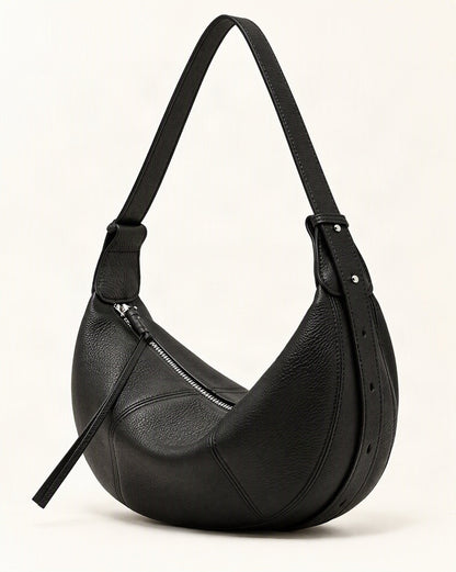 Cowhide Leather Crescent Hobo Crossbody Bag — front three-quarter view on a warm white background