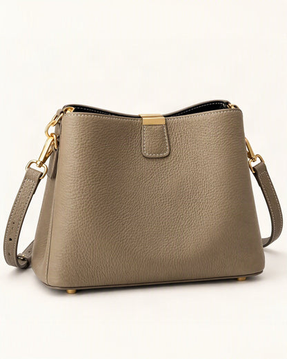 Cowhide Leather Crescent Bucket Bag — front three-quarter view on a warm white background