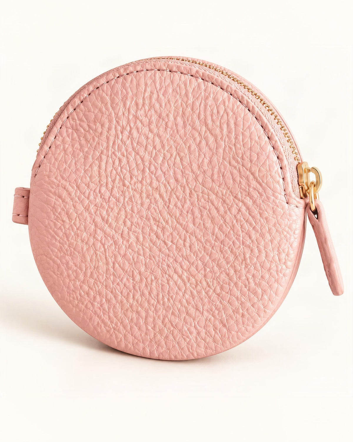 Cowhide Leather Mini Round Zip Pouch — front three-quarter view on a warm white background