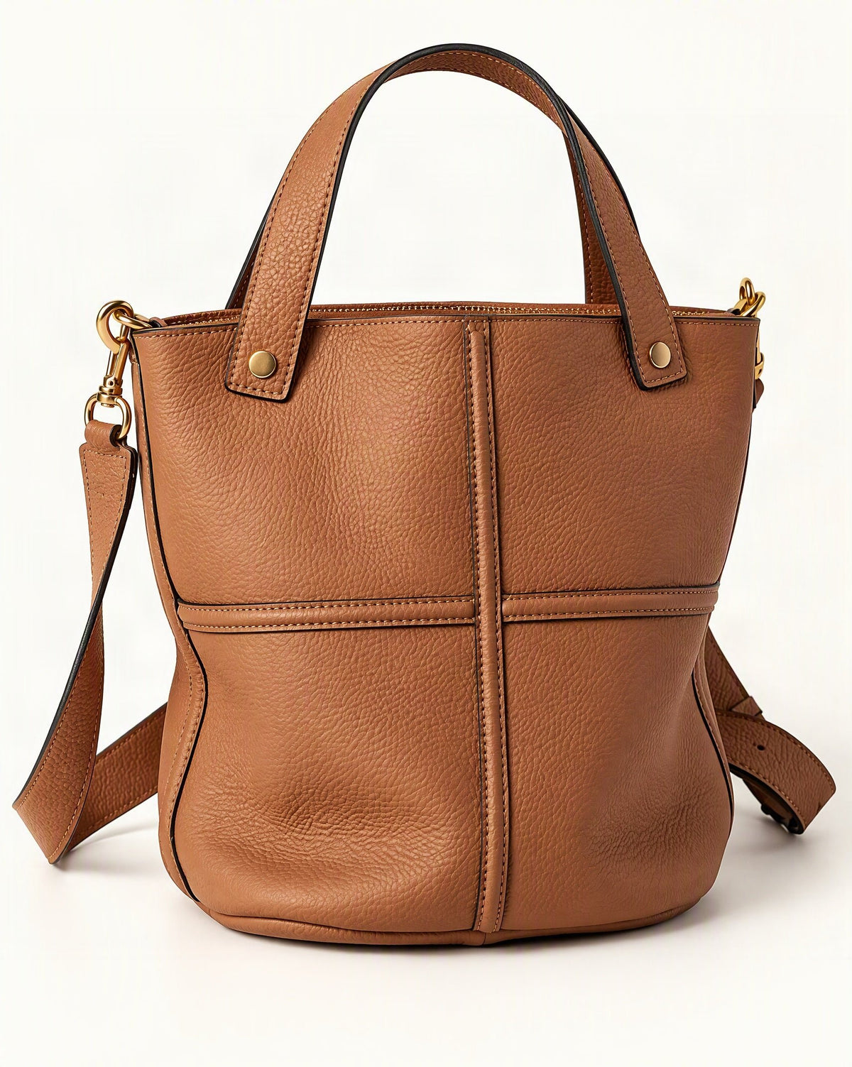 Top-Grain Cowhide Bucket Bag with Detachable Crossbody Strap — front three-quarter view on a warm white background