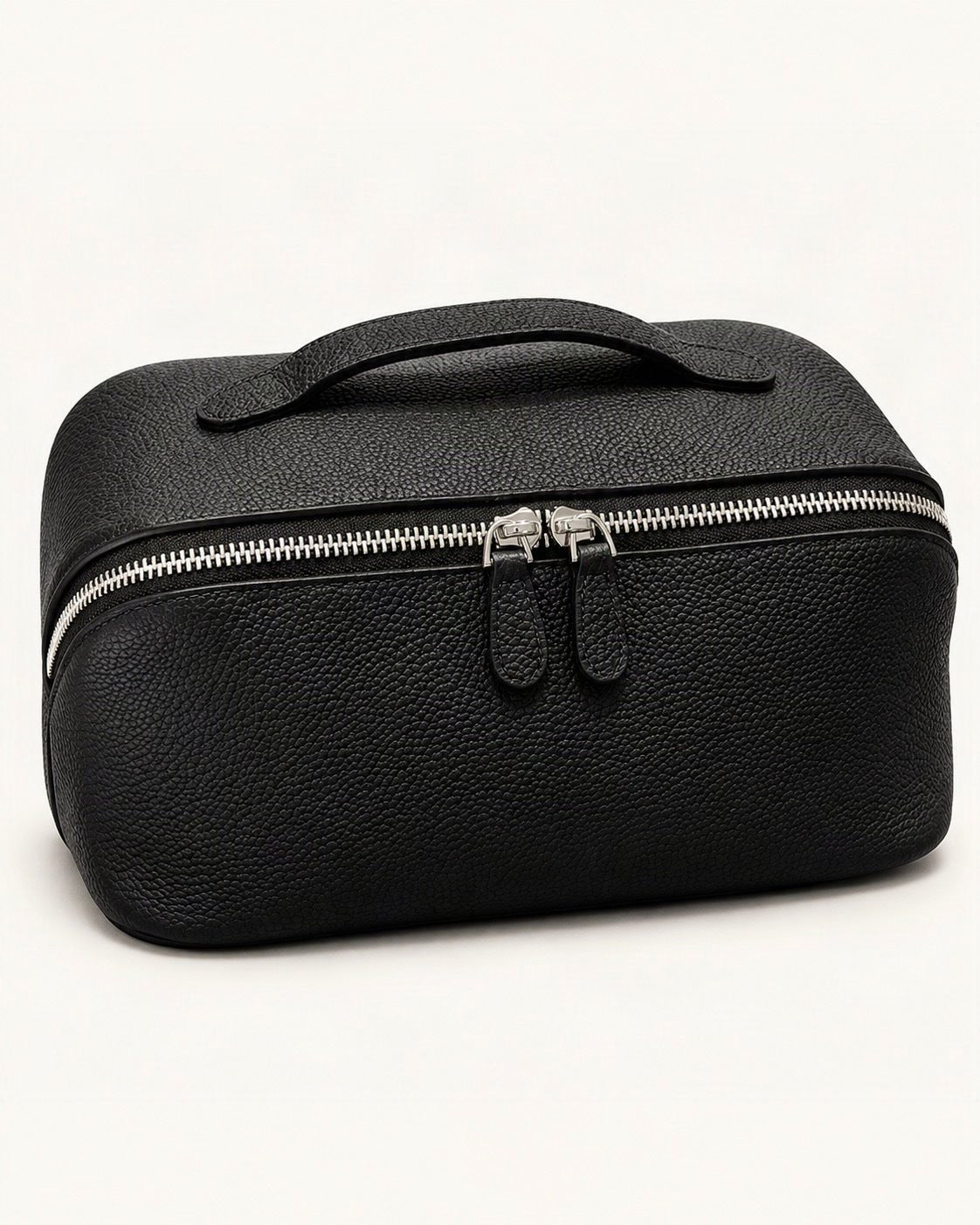 Top-Grain Cowhide Cosmetic Pouch — front three-quarter view on a warm white background