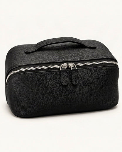 Top-Grain Cowhide Cosmetic Pouch — front three-quarter view on a warm white background