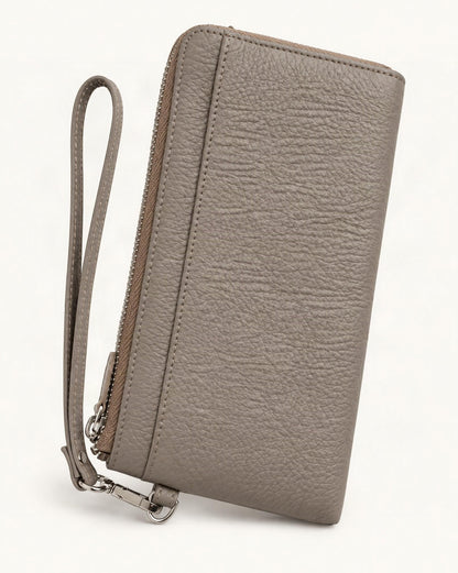 RFID-Blocking Pebbled Cowhide Long Zip Clutch — front three-quarter view on a warm white background