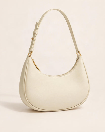 Cowhide Leather Crescent Hobo Shoulder Bag — front three-quarter view on a warm white background