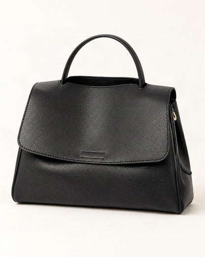 Cowhide Leather Mini Top-Handle Crossbody Bag — front three-quarter view on a warm white background