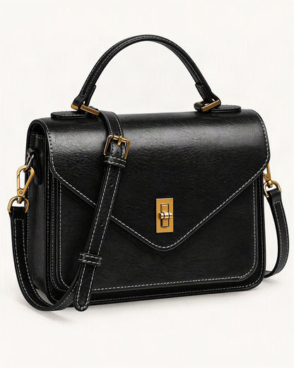 Cowhide Leather Small Messenger Crossbody Bag — front three-quarter view on a warm white background