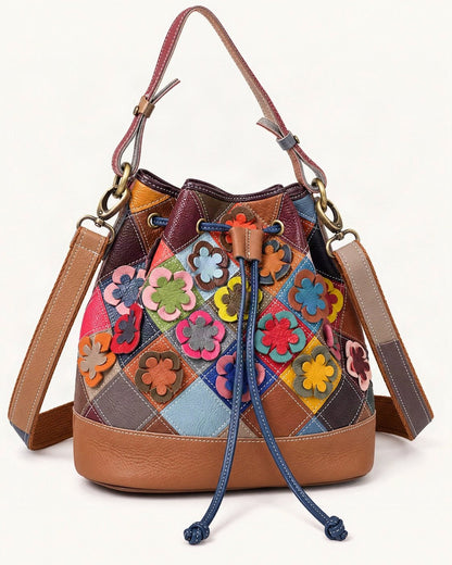 Top-Grain Cowhide Small Bucket Shoulder Bag — front three-quarter view on a warm white background