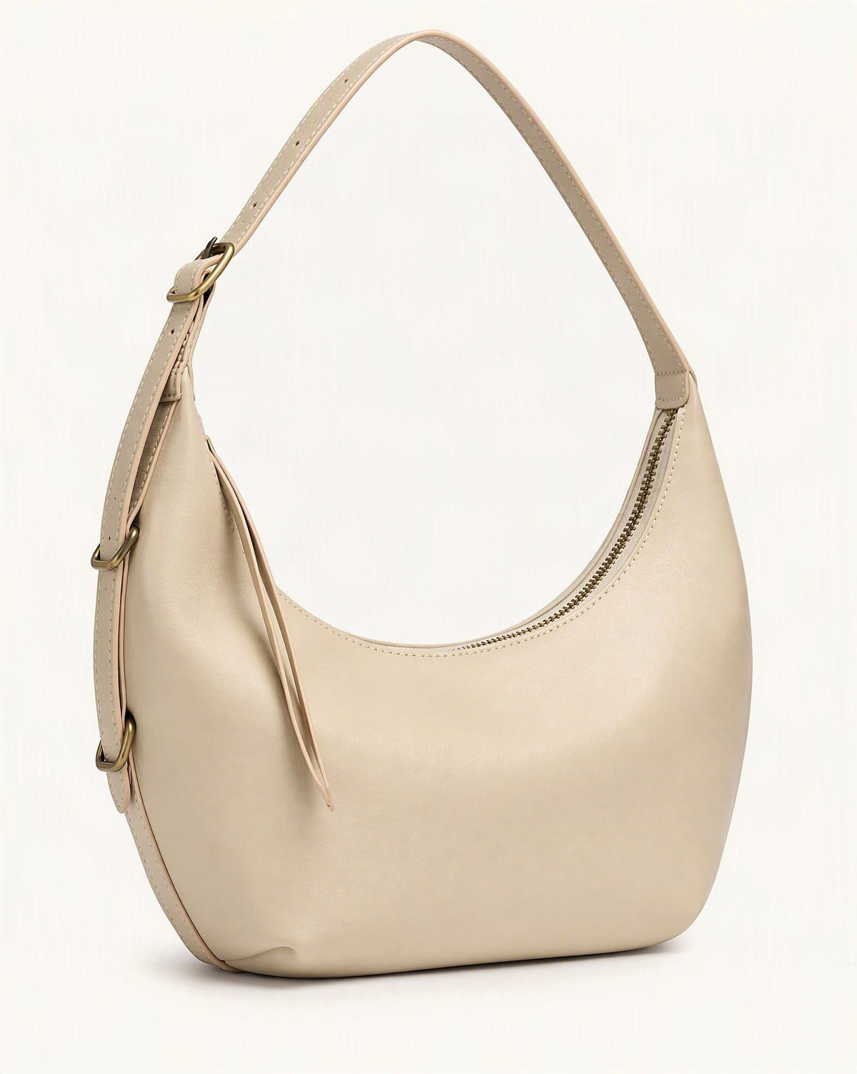 Cowhide Crescent Shoulder Bag — front three-quarter view on a warm white background