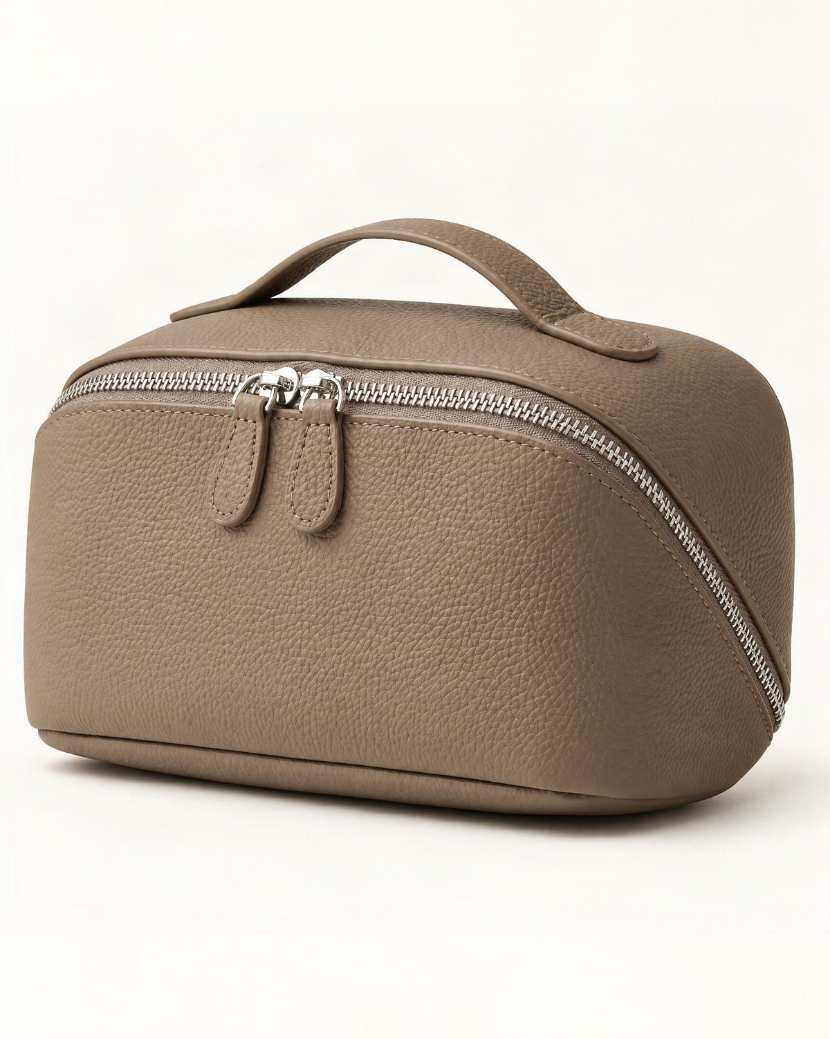 Cowhide Leather Travel Pouch with Top Handle — front three-quarter view on a warm white background