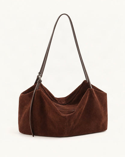 Suede Cowhide Zip Shoulder Tote Bag — front three-quarter view on a warm white background