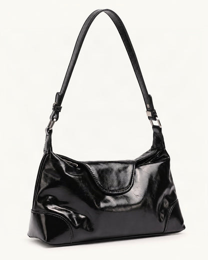Cowhide Leather Small Shoulder Bag with Adjustable Strap — front three-quarter view on a warm white background