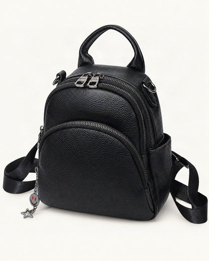Top-Grain Cowhide Convertible Backpack — front three-quarter view on a warm white background