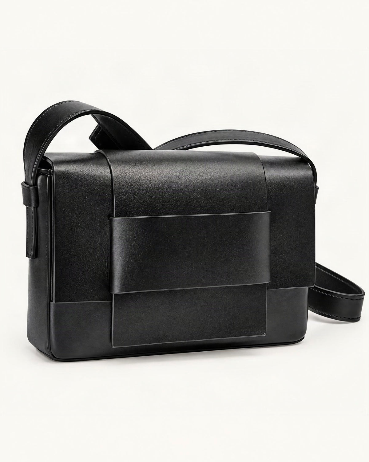 Cowhide Leather Mini Crossbody Bag with Bow Detail — front three-quarter view on a warm white background