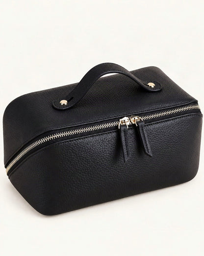 Top-Grain Cowhide Cosmetic Pouch with Double Zippers — front three-quarter view on a warm white background