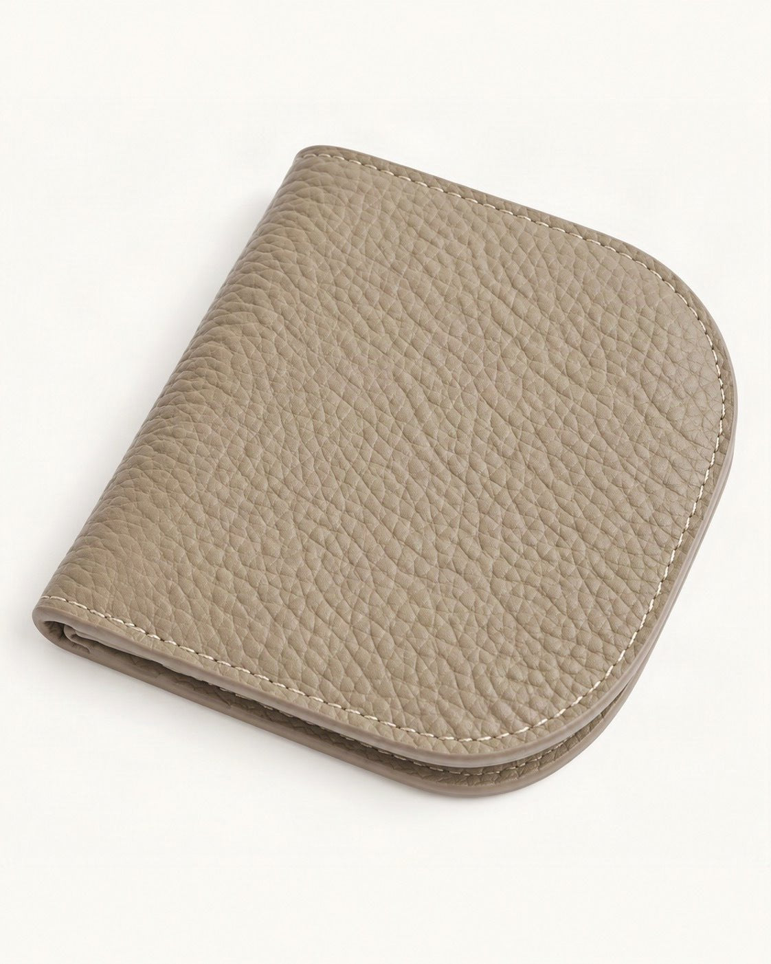 Cowhide Leather Compact Bifold Wallet — front three-quarter view on a warm white background