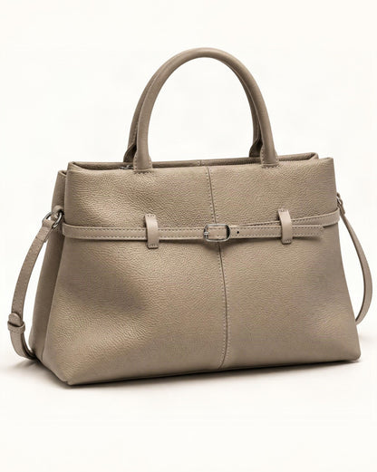 Cowhide Leather Small Tote Bag with Adjustable Strap — front three-quarter view on a warm white background