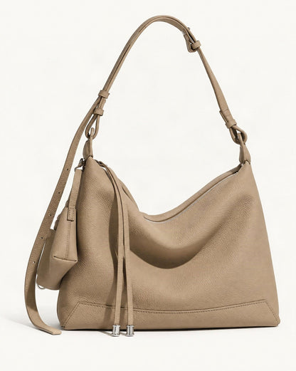 Cowhide Leather Soft Hobo Shoulder Bag — front three-quarter view on a warm white background