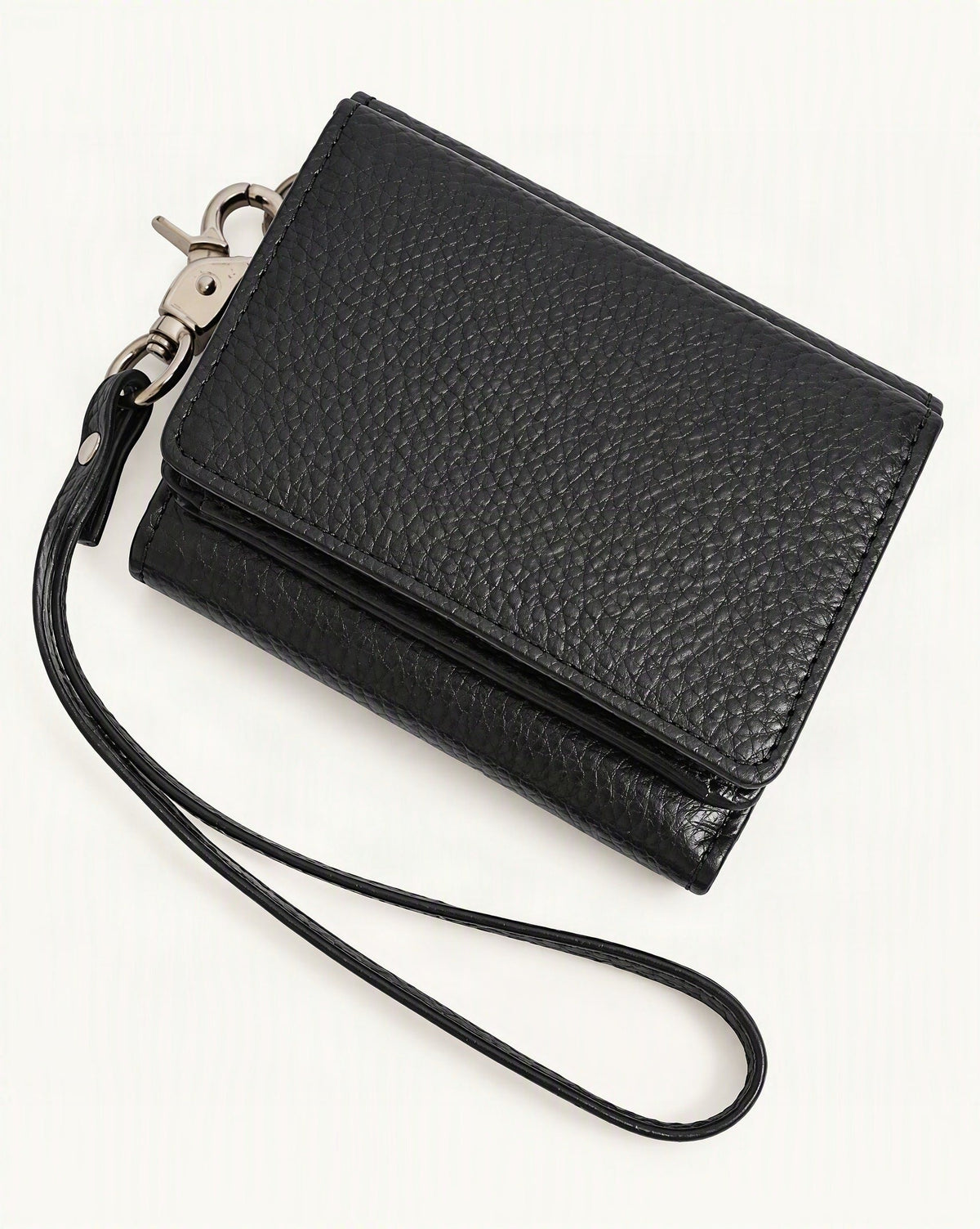 Cowhide Leather Tri-Fold RFID-Blocking Wallet — front three-quarter view on a warm white background