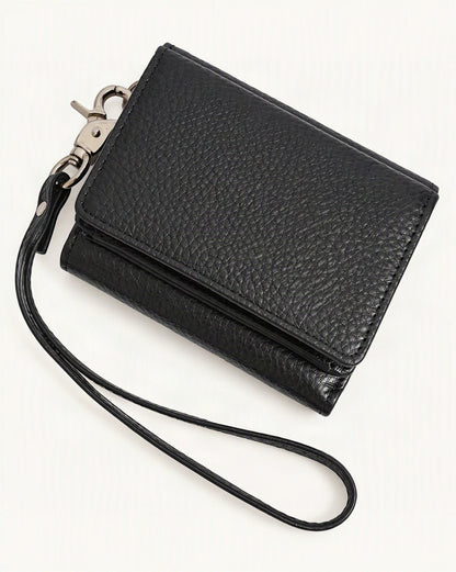 Cowhide Leather Tri-Fold RFID-Blocking Wallet — front three-quarter view on a warm white background