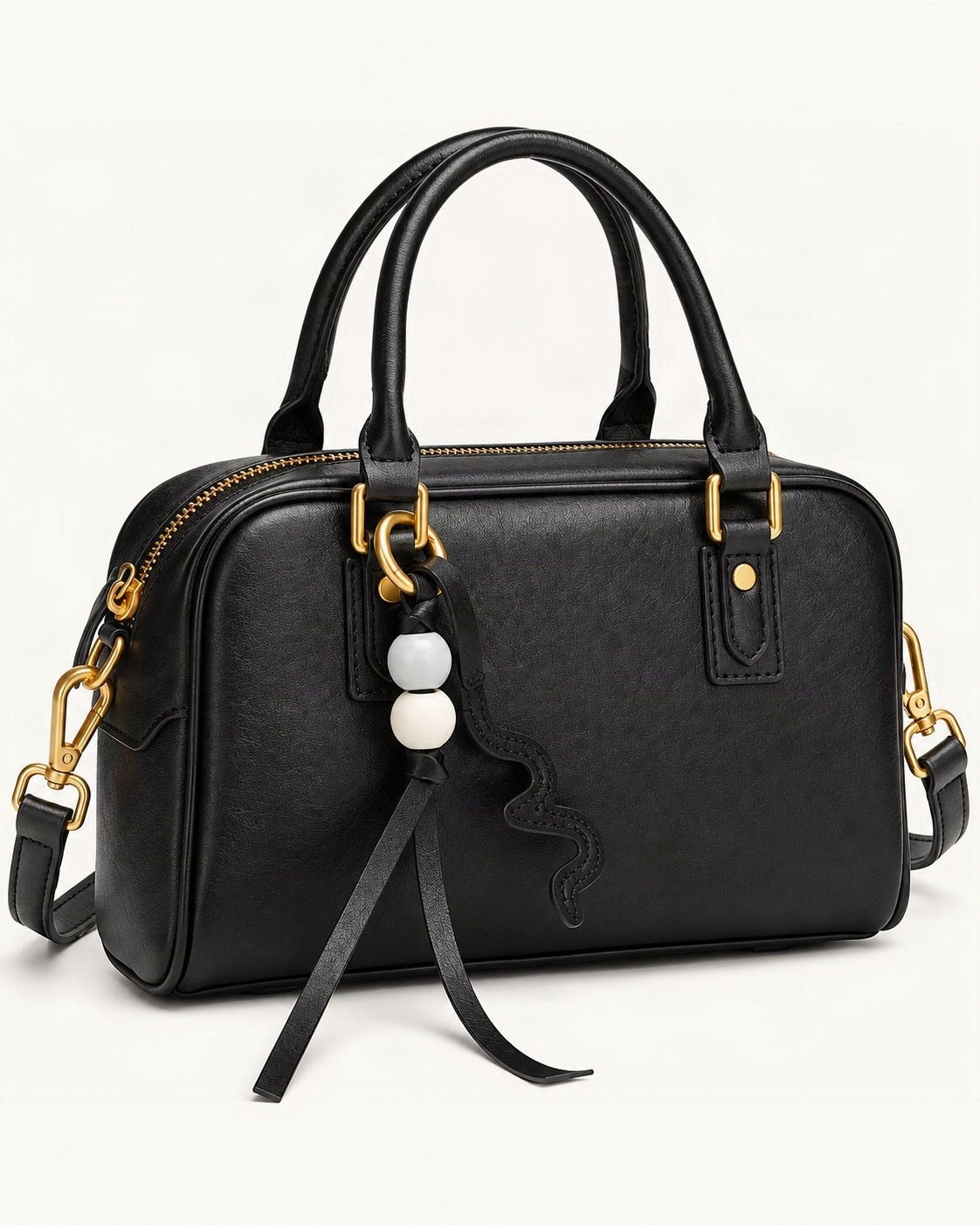 Cowhide Leather Double-Handle Pillow Crossbody Bag — front three-quarter view on a warm white background