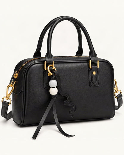 Cowhide Leather Double-Handle Pillow Crossbody Bag — front three-quarter view on a warm white background