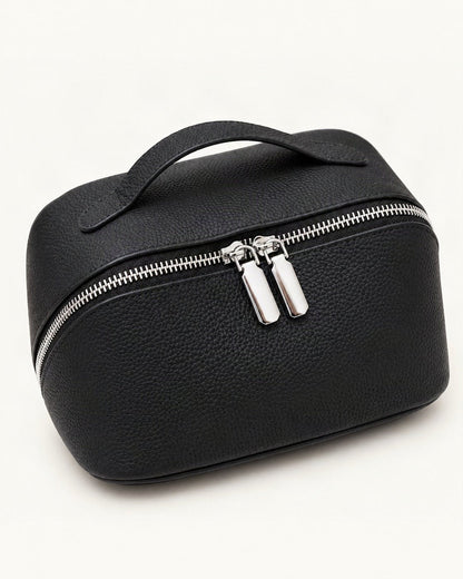 Top-Grain Cowhide Cosmetic Pouch — front three-quarter view on a warm white background