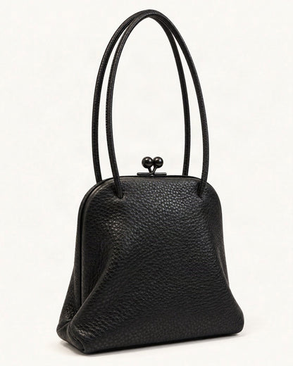 Leather Mini Shoulder Bag — front three-quarter view on a warm white background