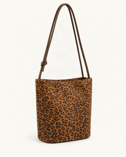 Nubuck Cowhide Bucket Crossbody Bag — front three-quarter view on a warm white background
