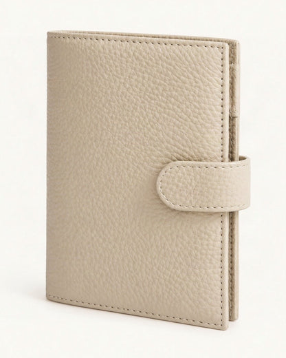 Leather Passport Holder Wallet with Pen Slot — front three-quarter view on a warm white background