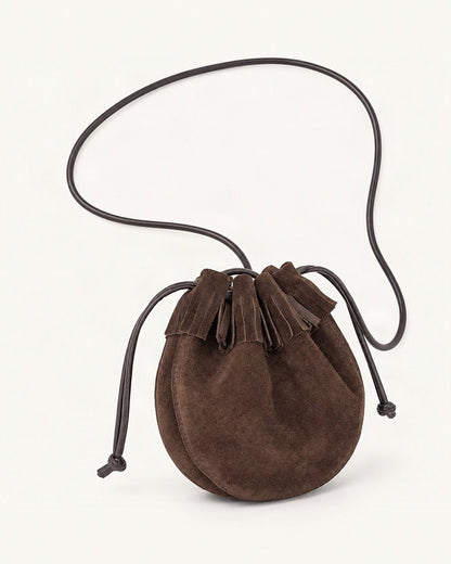 Suede Cowhide Micro Bucket Bag — front three-quarter view on a warm white background