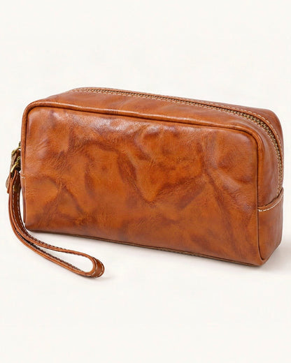 Vegetable-Tanned Leather Cosmetic Wristlet Pouch — front three-quarter view on a warm white background