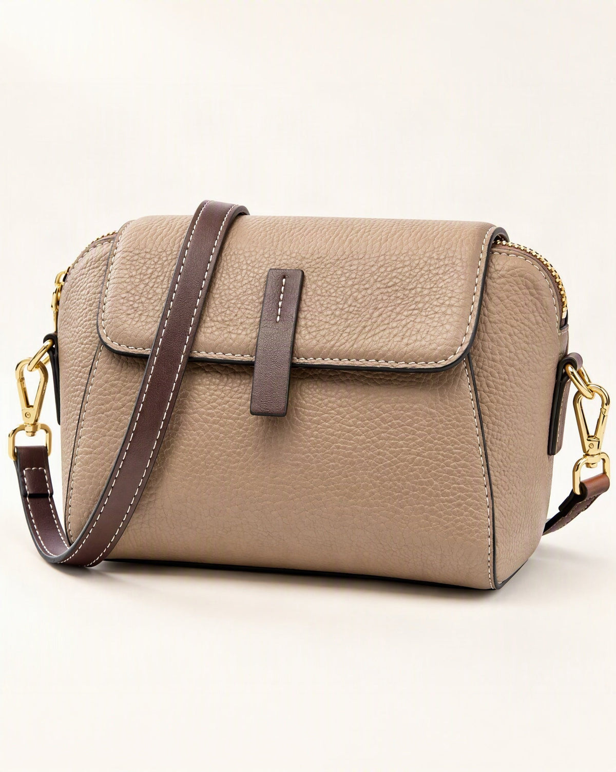 Cowhide Small Shell Crossbody Bag — front three-quarter view on a warm white background
