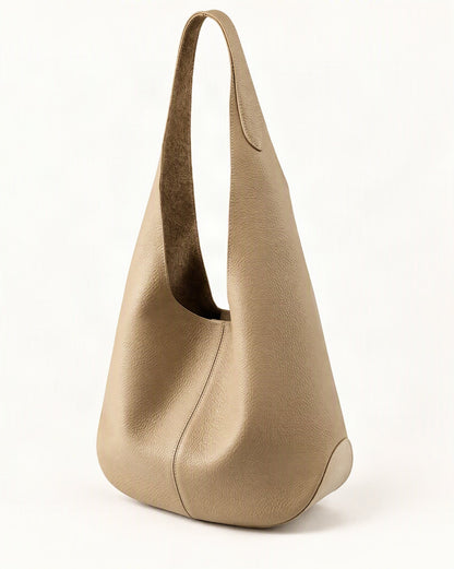 Cowhide Leather Small Bucket Tote Shoulder Bag — front three-quarter view on a warm white background