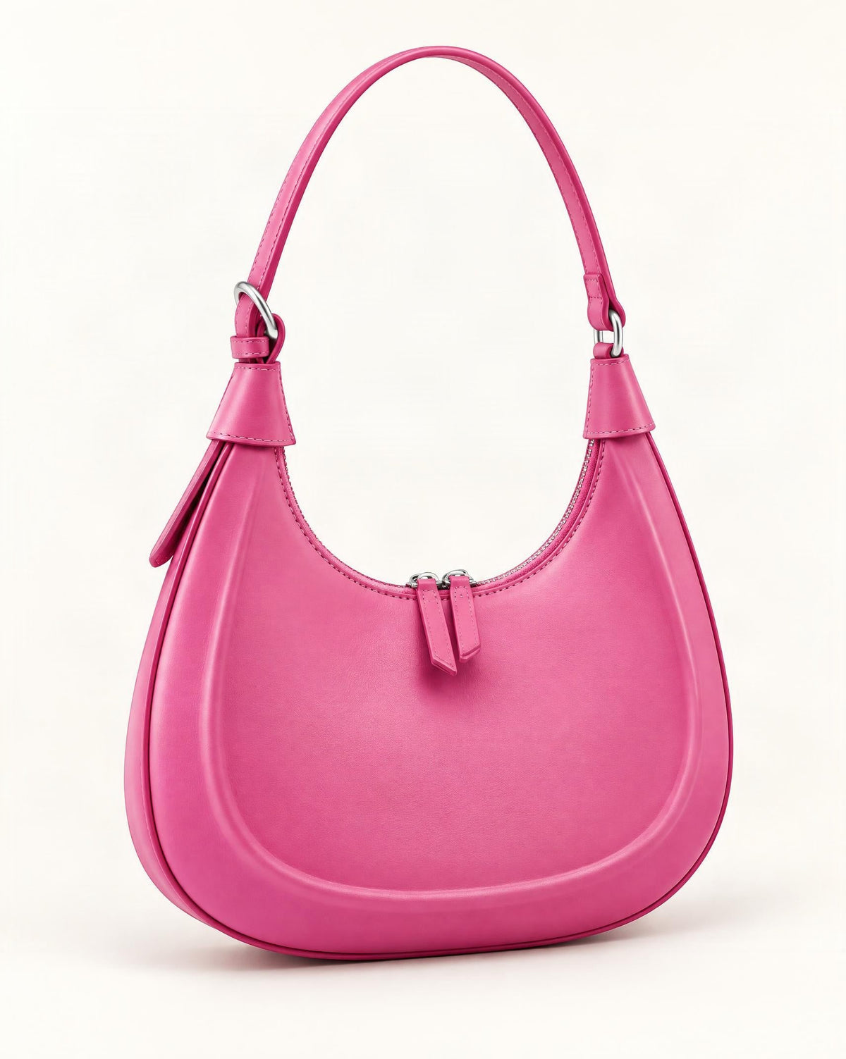 Cowhide Crescent Moon Bag — front three-quarter view on a warm white background