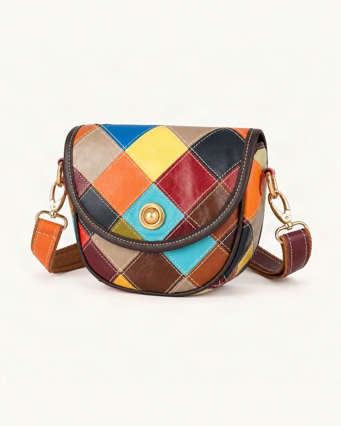 Cowhide Patchwork Crossbody Bag — front three-quarter view on a warm white background