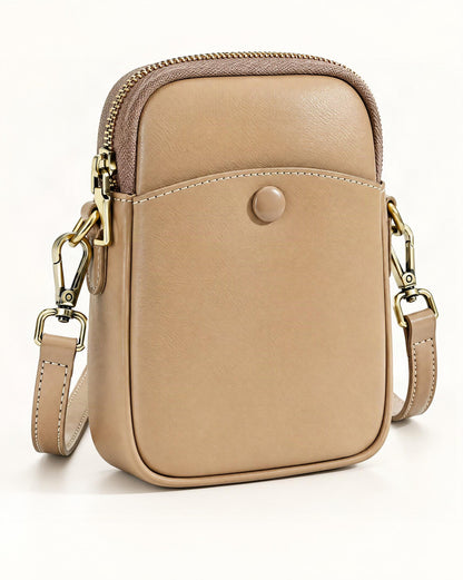 Cowhide Leather Micro Crossbody Bag with Adjustable Strap — front three-quarter view on a warm white background