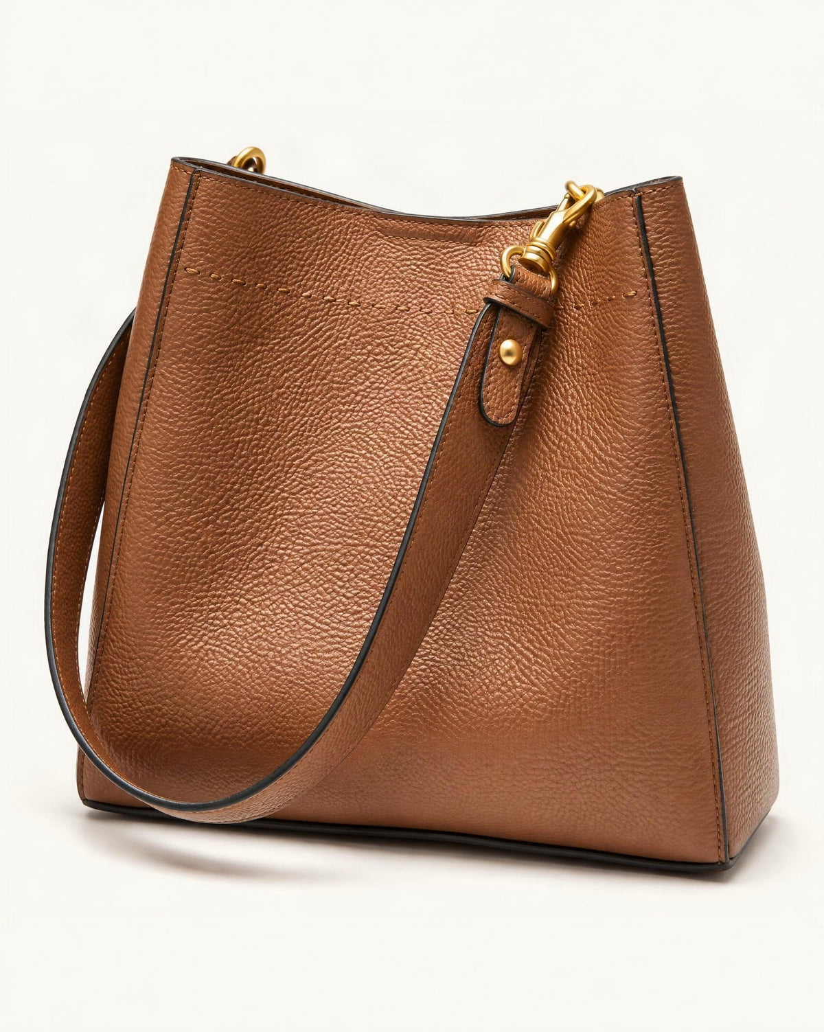 Cowhide Leather Small Bucket Tote Bag — front three-quarter view on a warm white background