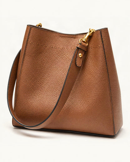 Cowhide Leather Small Bucket Tote Bag — front three-quarter view on a warm white background
