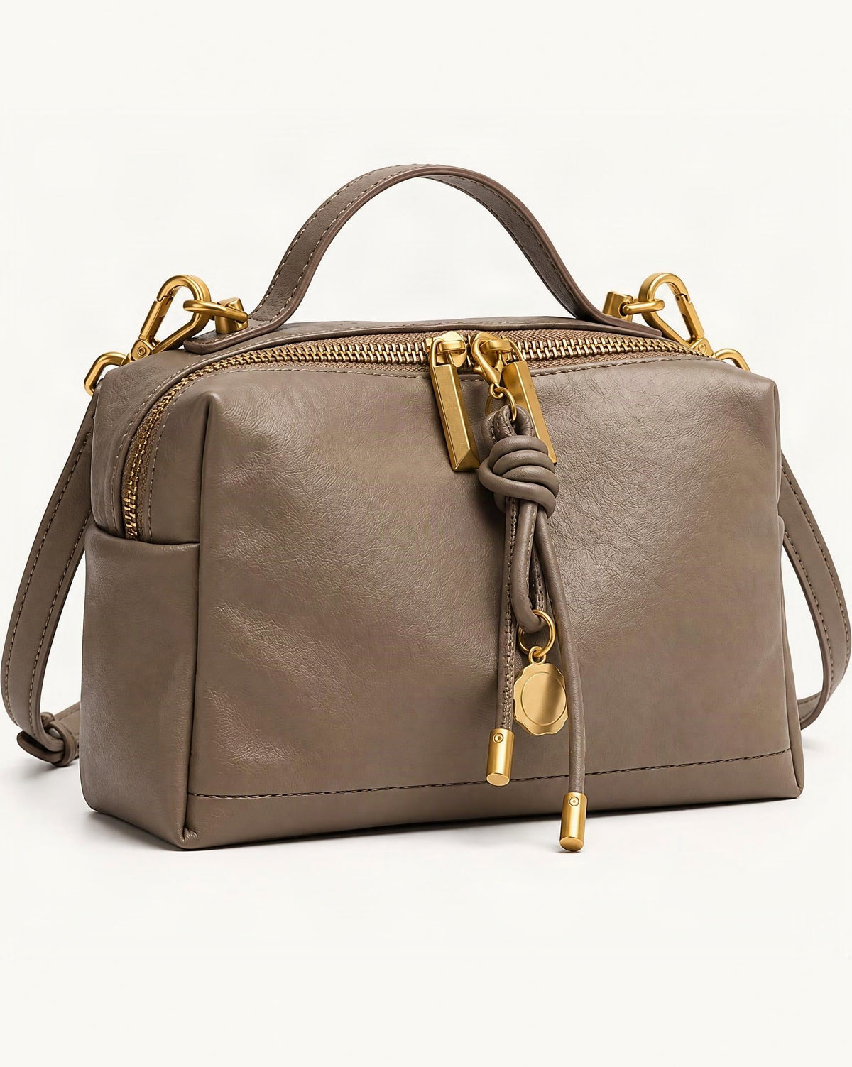 Cowhide Leather Small Crossbody Bag — front three-quarter view on a warm white background