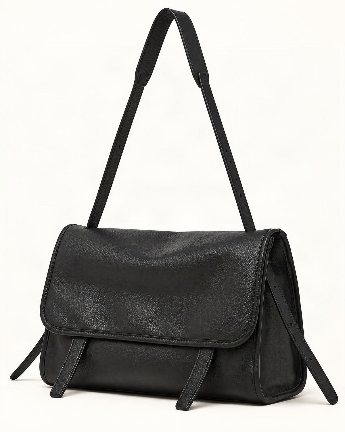 Cowhide Leather Messenger Crossbody Bag — front three-quarter view on a warm white background