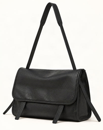 Cowhide Leather Messenger Crossbody Bag — front three-quarter view on a warm white background