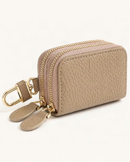 Cowhide Leather Compact Key Case with Clip — front three-quarter view on a warm white background