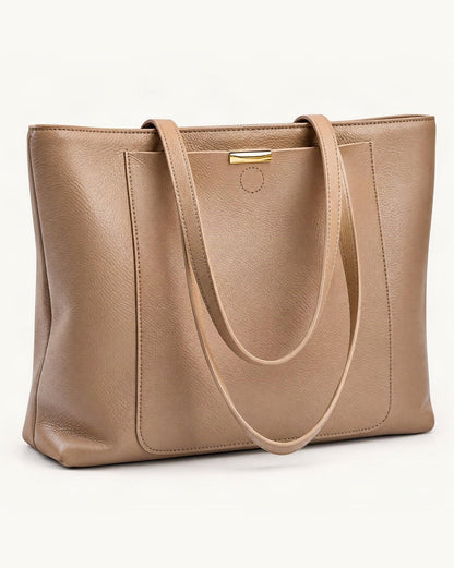 Pebbled Cowhide Leather Tote Bag — front three-quarter view on a warm white background