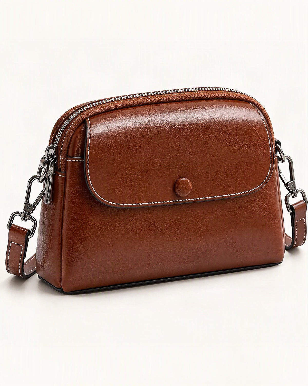 Cowhide Mini Crossbody Bag with Snap Flap, Oil-Waxed Leather — front three-quarter view on a warm white background