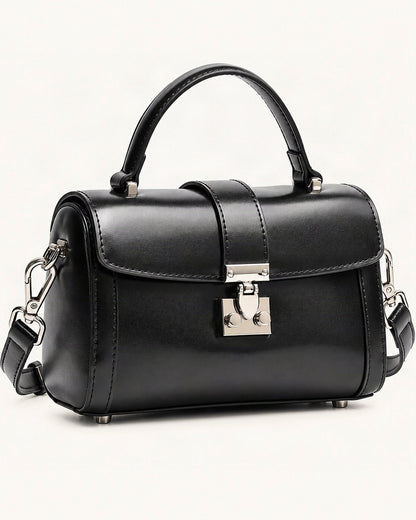Cowhide Leather Mini Box Crossbody Bag with Lock Clasp — front three-quarter view on a warm white background